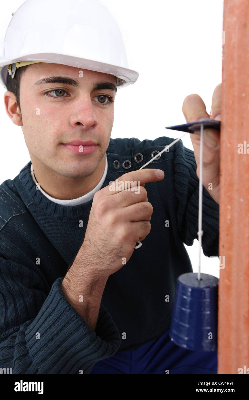 Worker using a plumbline Stock Photo Alamy