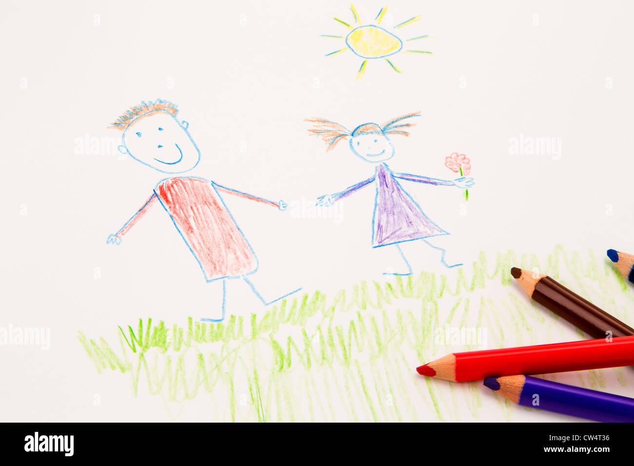 A genuine kid's drawing with some coloured pencils. Stock Photo