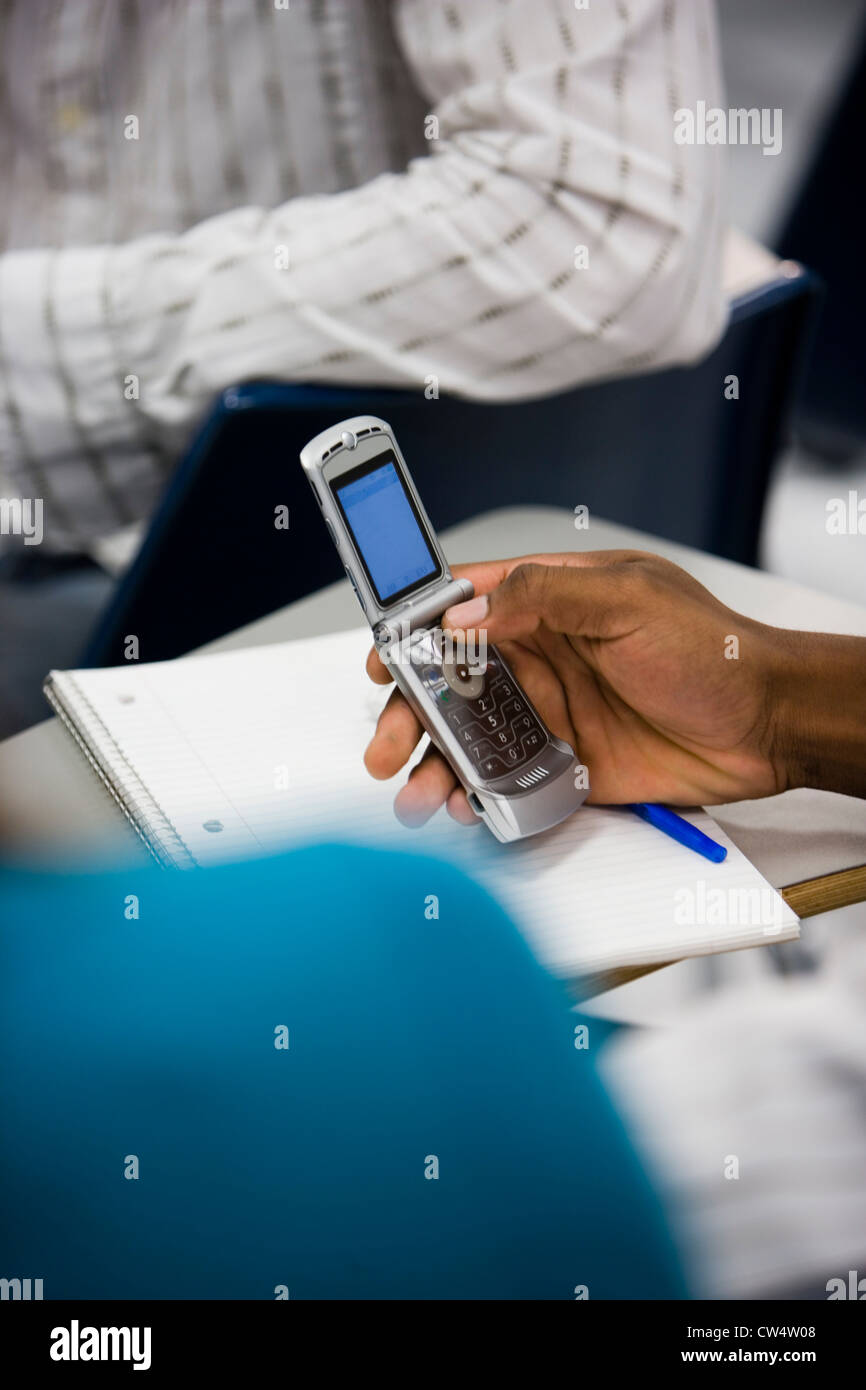 Person using a mobile phone in the classroom Stock Photo - Alamy