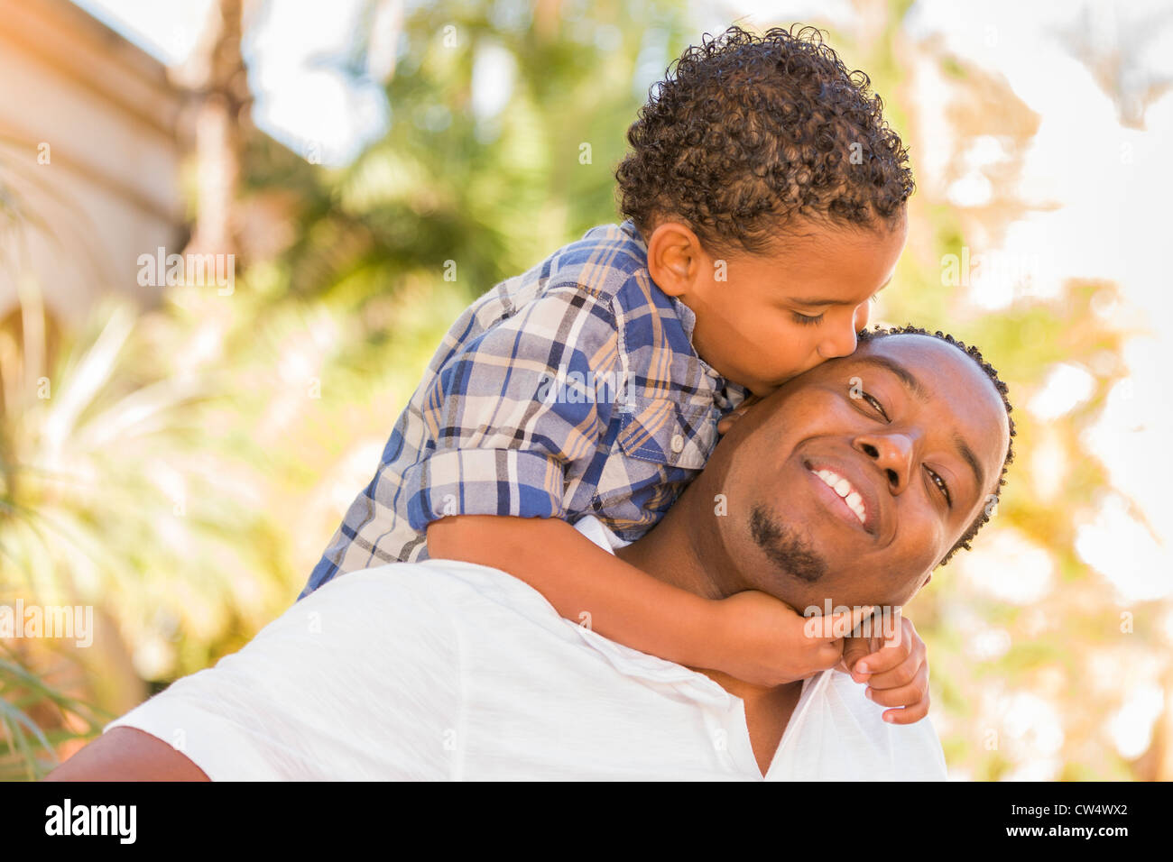 Happy African American Father and Mixed Race Son Playing Piggyback in ...