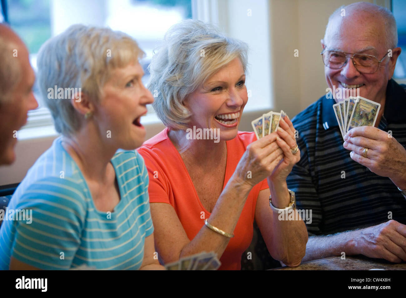 Close-up of a senior men and women playing cards Stock Photo