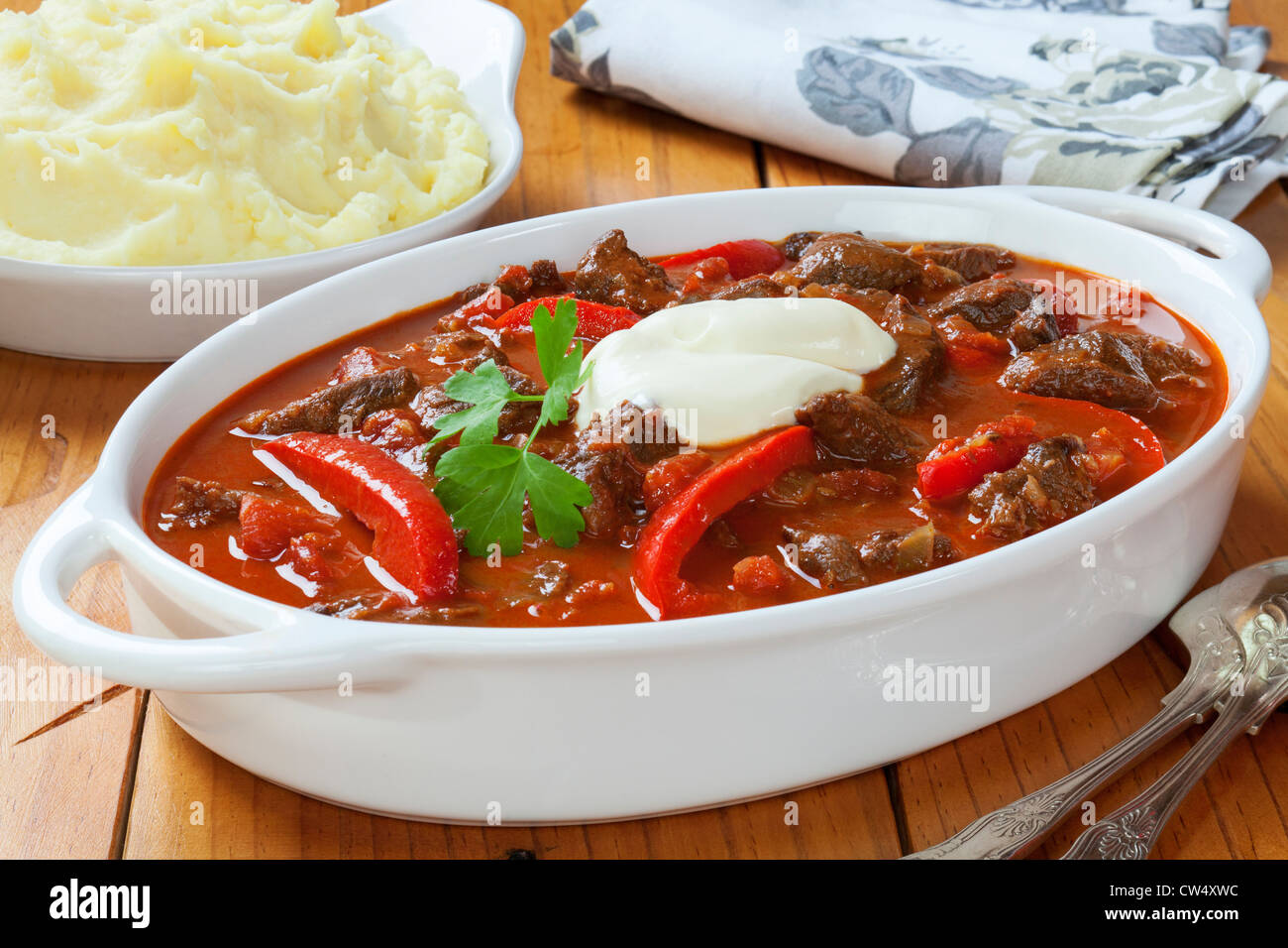 Goulash with red peppers and sour cream and a side dish of mashed