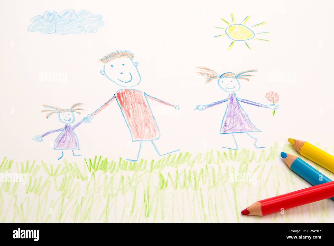 A genuine kid's drawing of a family using some coloured pencils. Stock Photo