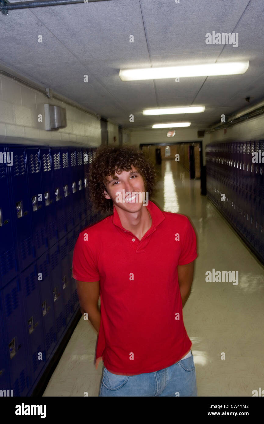 Portrait of cheerful male student standing by lockers Stock Photo - Alamy