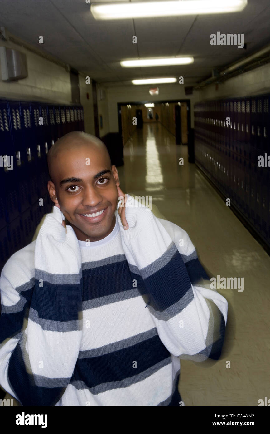 Portrait of cheerful male student standing by lockers Stock Photo - Alamy