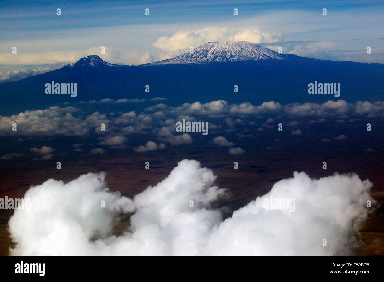 Aerial image of Mount Kilimanjaro, Africa's highest mountain, with snow and white puffy clouds from Kenya Stock Photo
