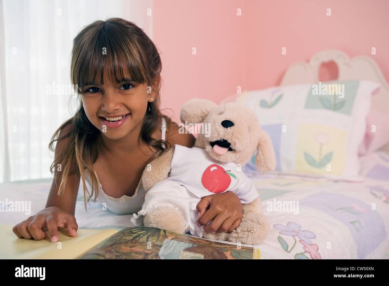 Portrait of a girl lying in the bed and smiling Stock Photo - Alamy