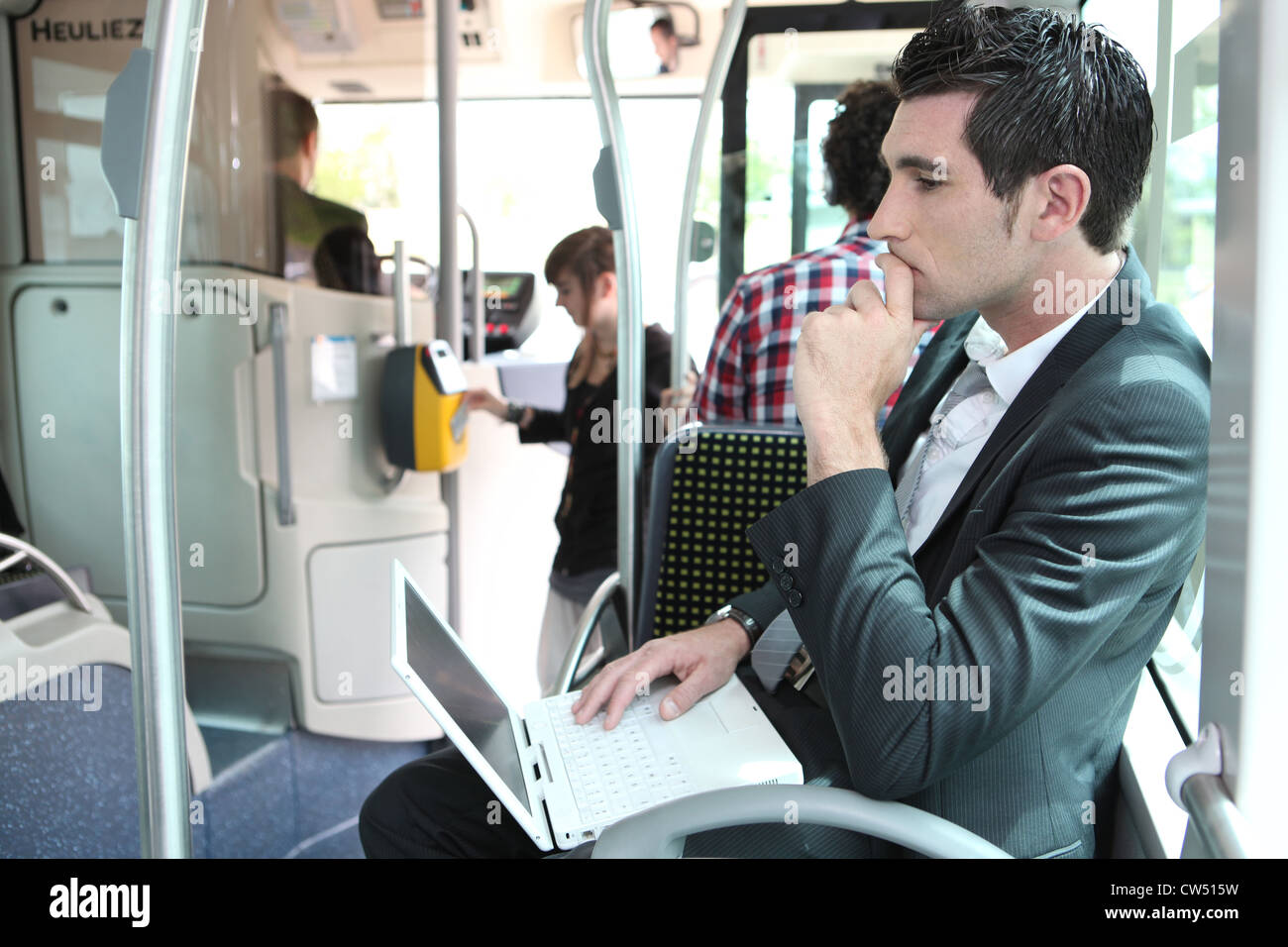 Commuter on a bus with a laptop Stock Photo - Alamy