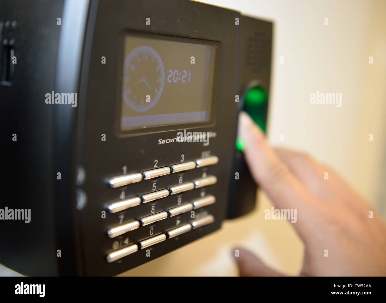 The worker use fingerprint touch security and time checking machine. Stock Photo