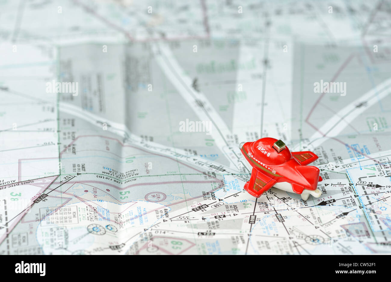 The red toy plane is on the route chart for traveling concept. Stock Photo