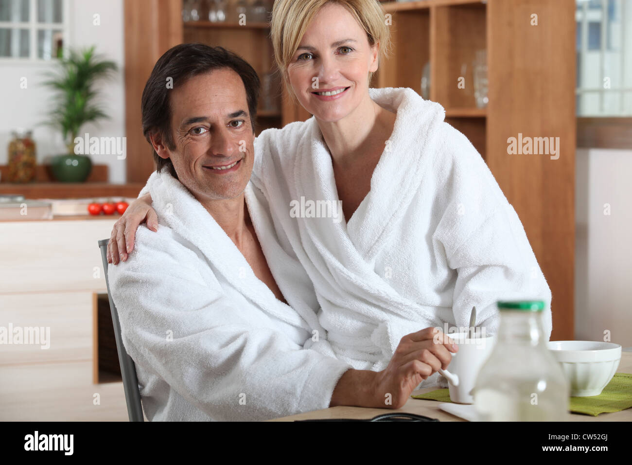 Breakfast In Robe Couple having breakfast in towelling robes Stock Photo - Alamy