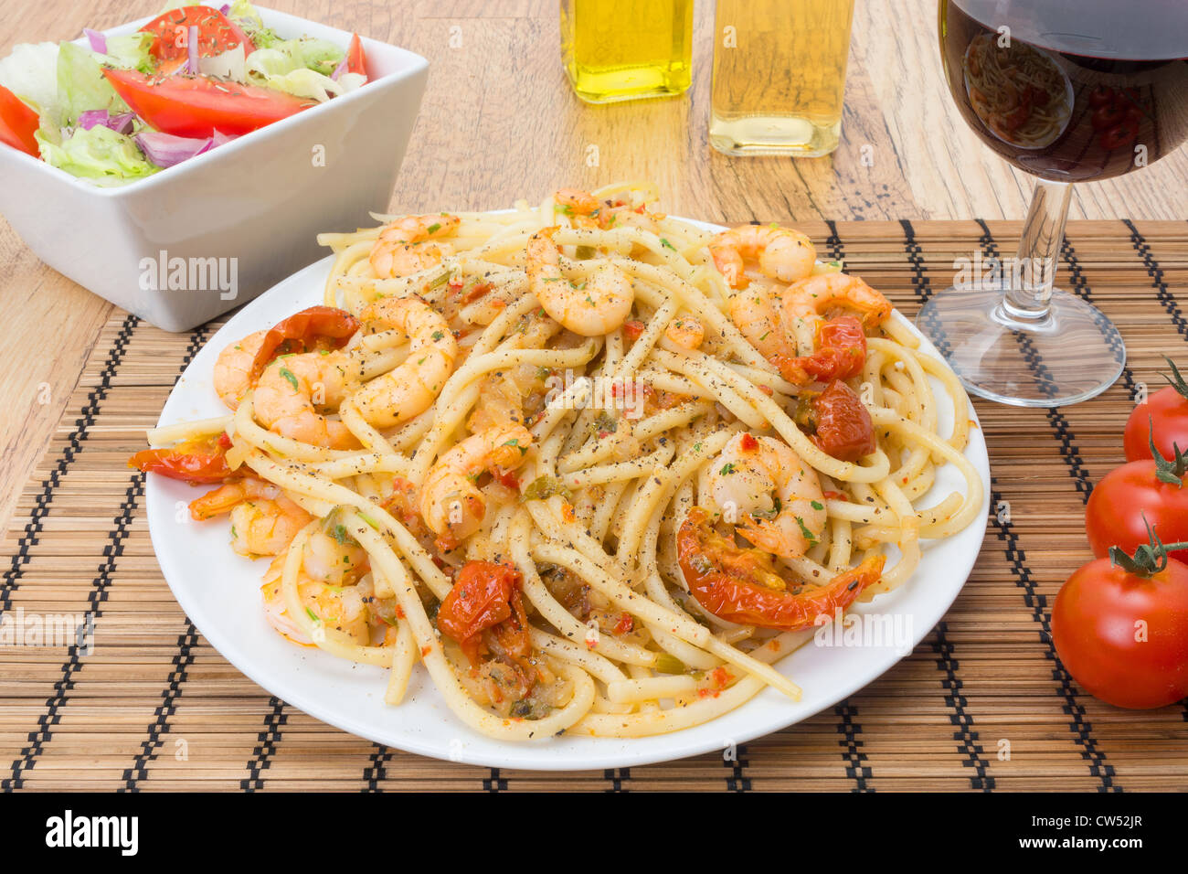 King prawns tossed through bucatini pasta and garnished with sun dried