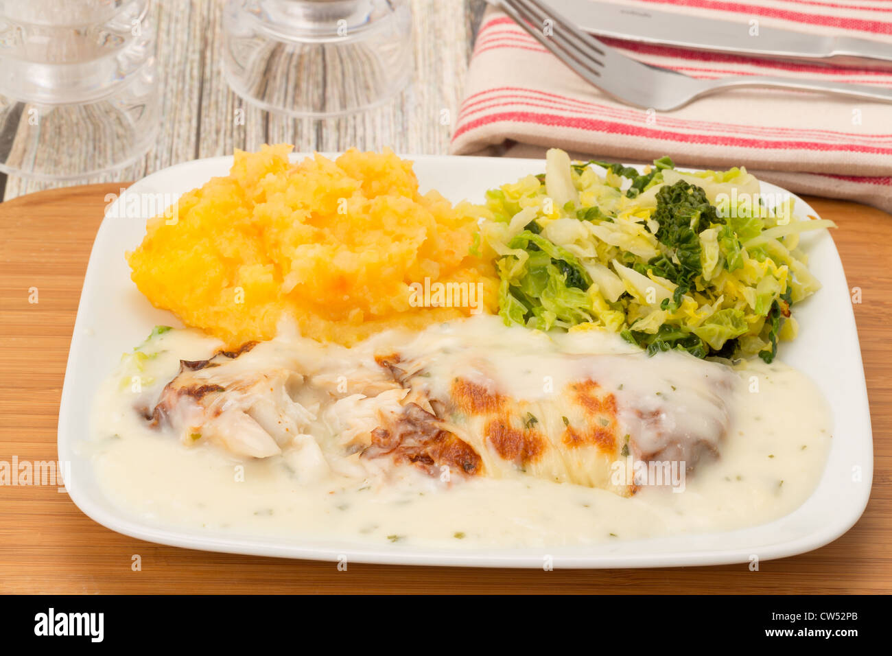 Smoked cod fillet in a cheese and parsley sauce served with potato