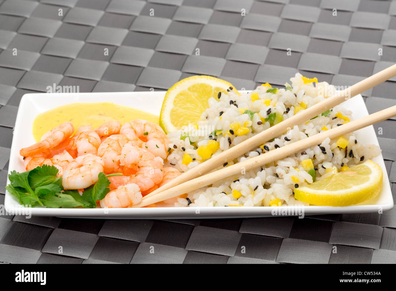 King prawn and fried rice served with a salad and coconut and mango dressing - studio shot with a shallow depth of field Stock Photo