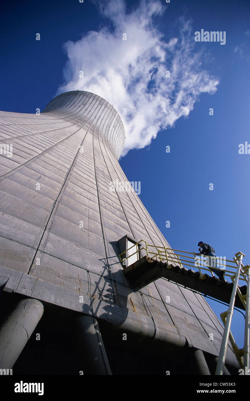 Low angle view of a person on the staircase of a smoke stack at a power plant Stock Photo