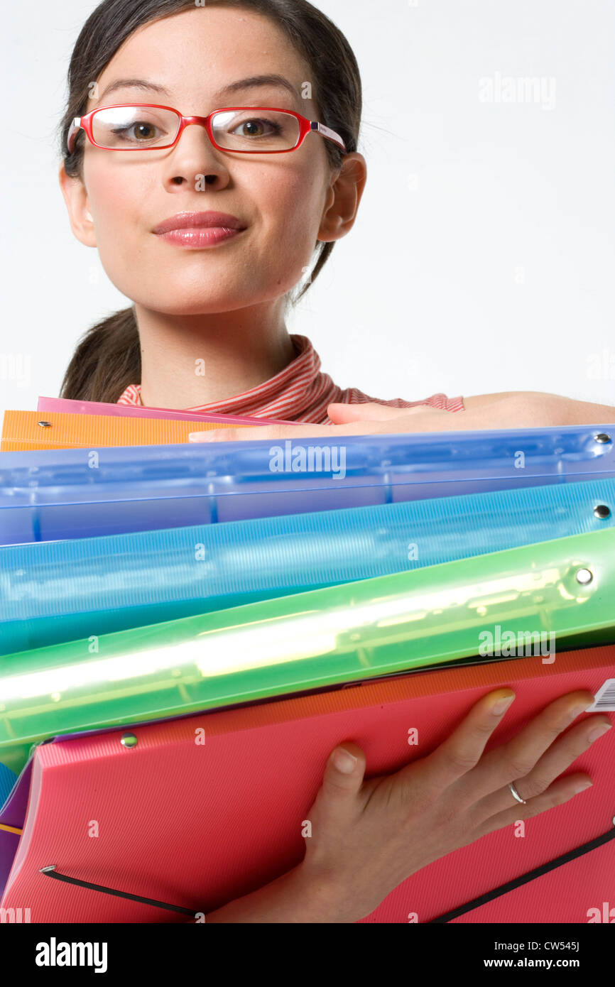 Low angle view of a businesswoman holding a stack of ring binders Stock Photo