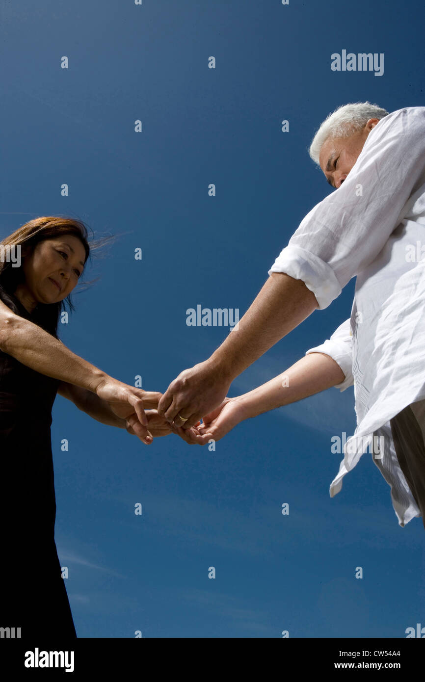 Low angle view of a mature couple holding hands Stock Photo