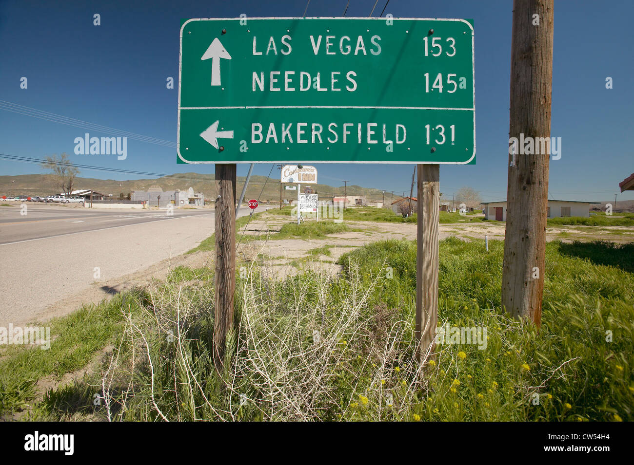 A highway sign pointing to Las Vegas, Bakersfield and Needles, CA Stock