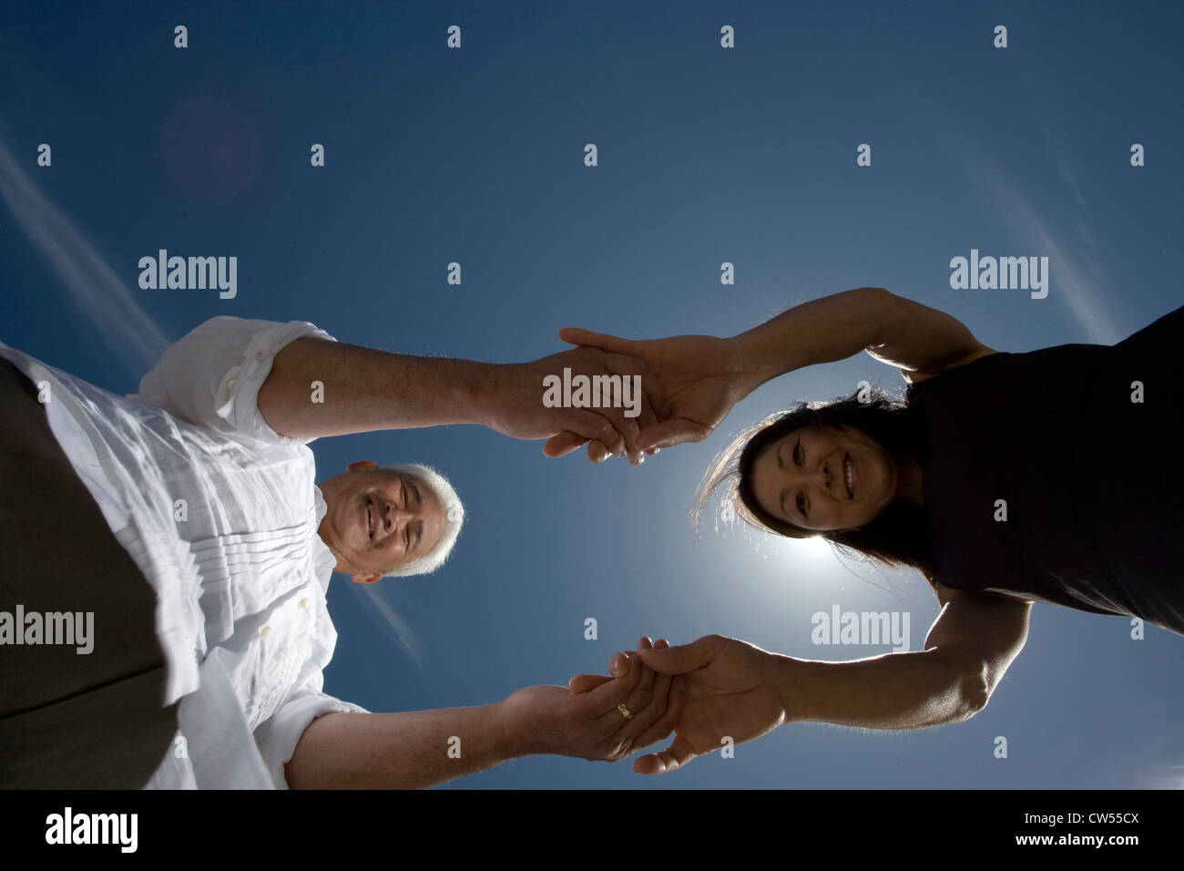 Low angle view of a mature couple holding hands Stock Photo