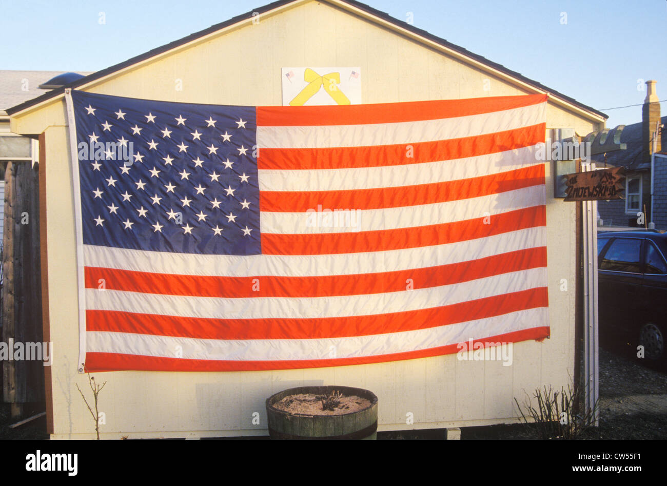 American Flag and Yellow Ribbon Hung on Shed Stock Photo