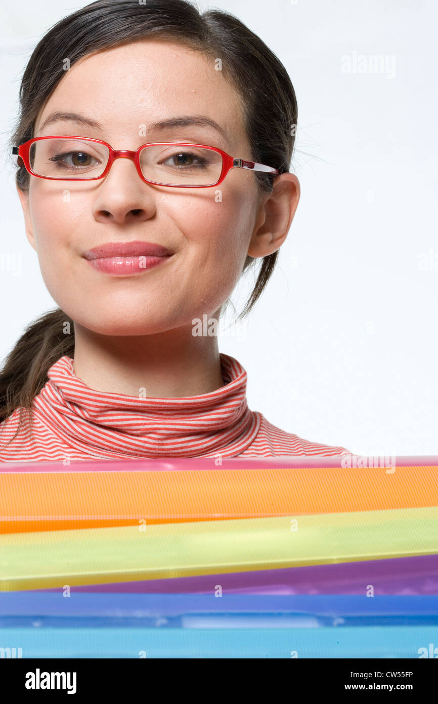 Low angle view of a businesswoman holding a stack of ring binders Stock Photo
