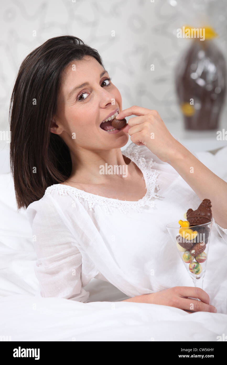 Woman eating Easter egg Stock Photo