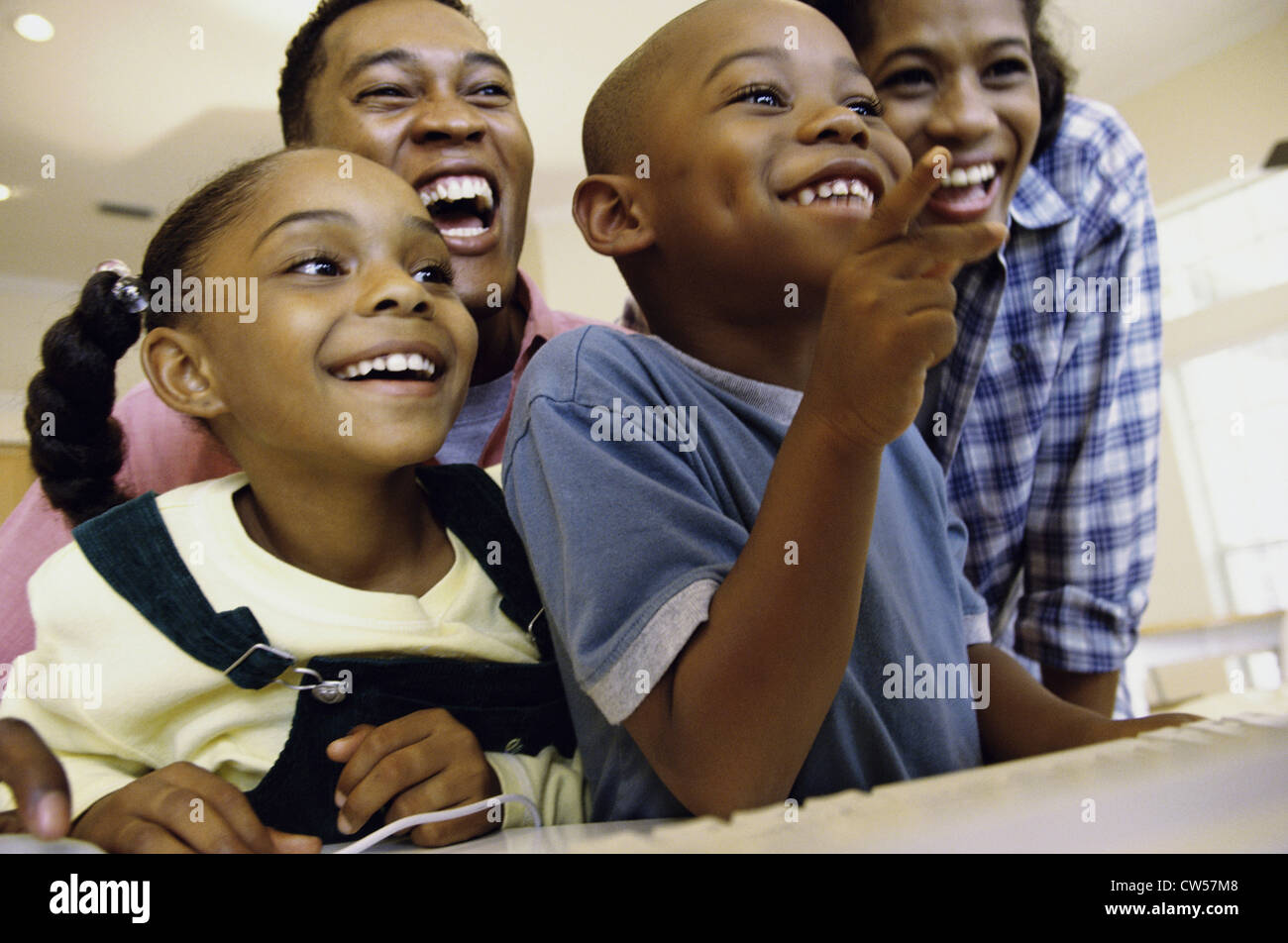 Low angle view of a family using a computer Stock Photo