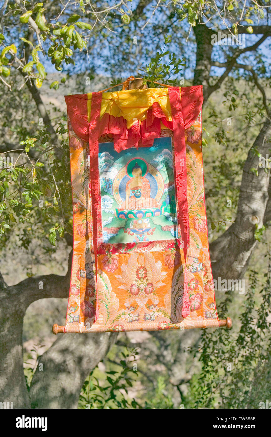 A colorful Buddhist tapestry hangs from a tree atop Meditation Mount in Ojai, CA Stock Photo