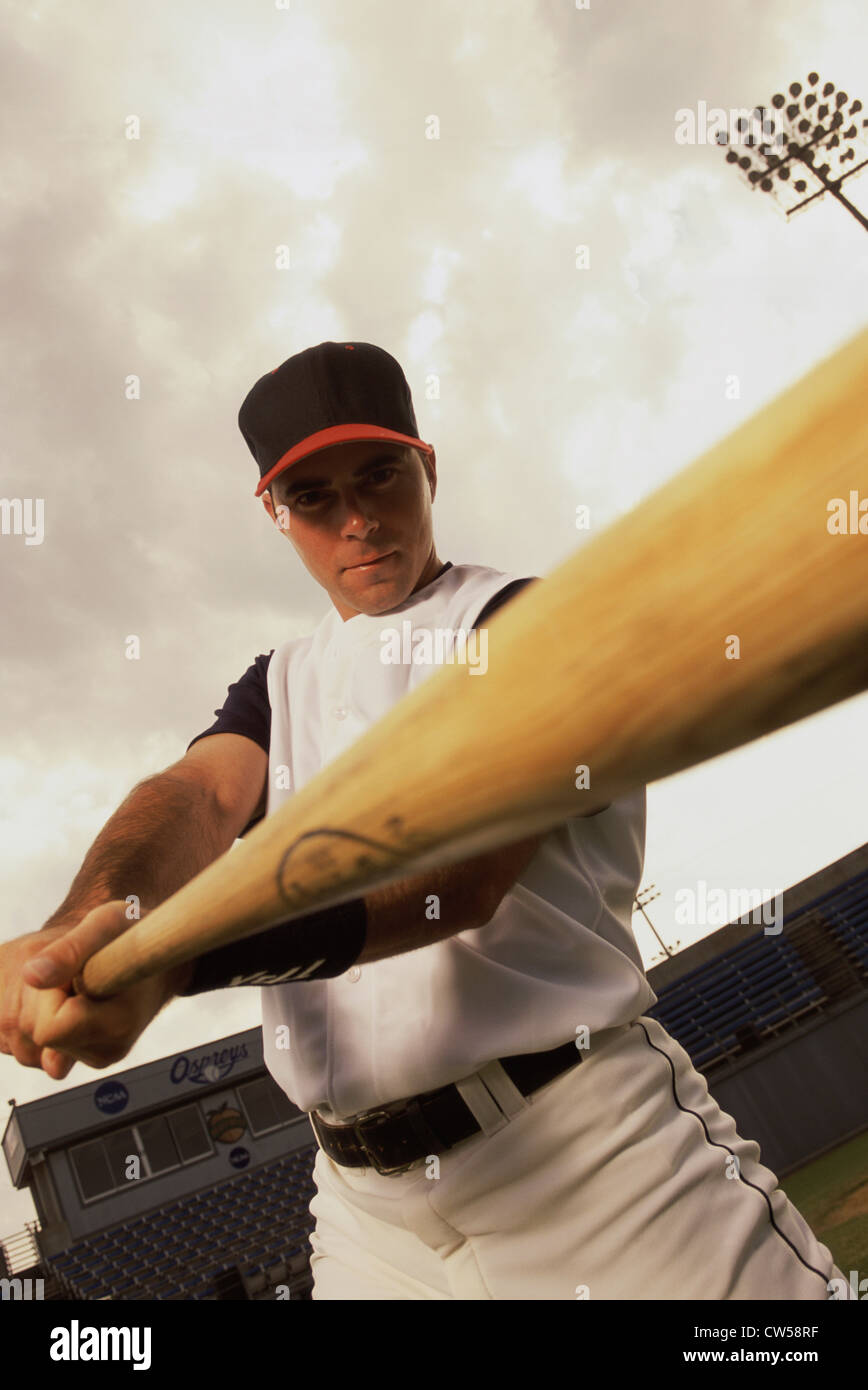 Low angle view of a baseball player swinging a baseball bat Stock Photo