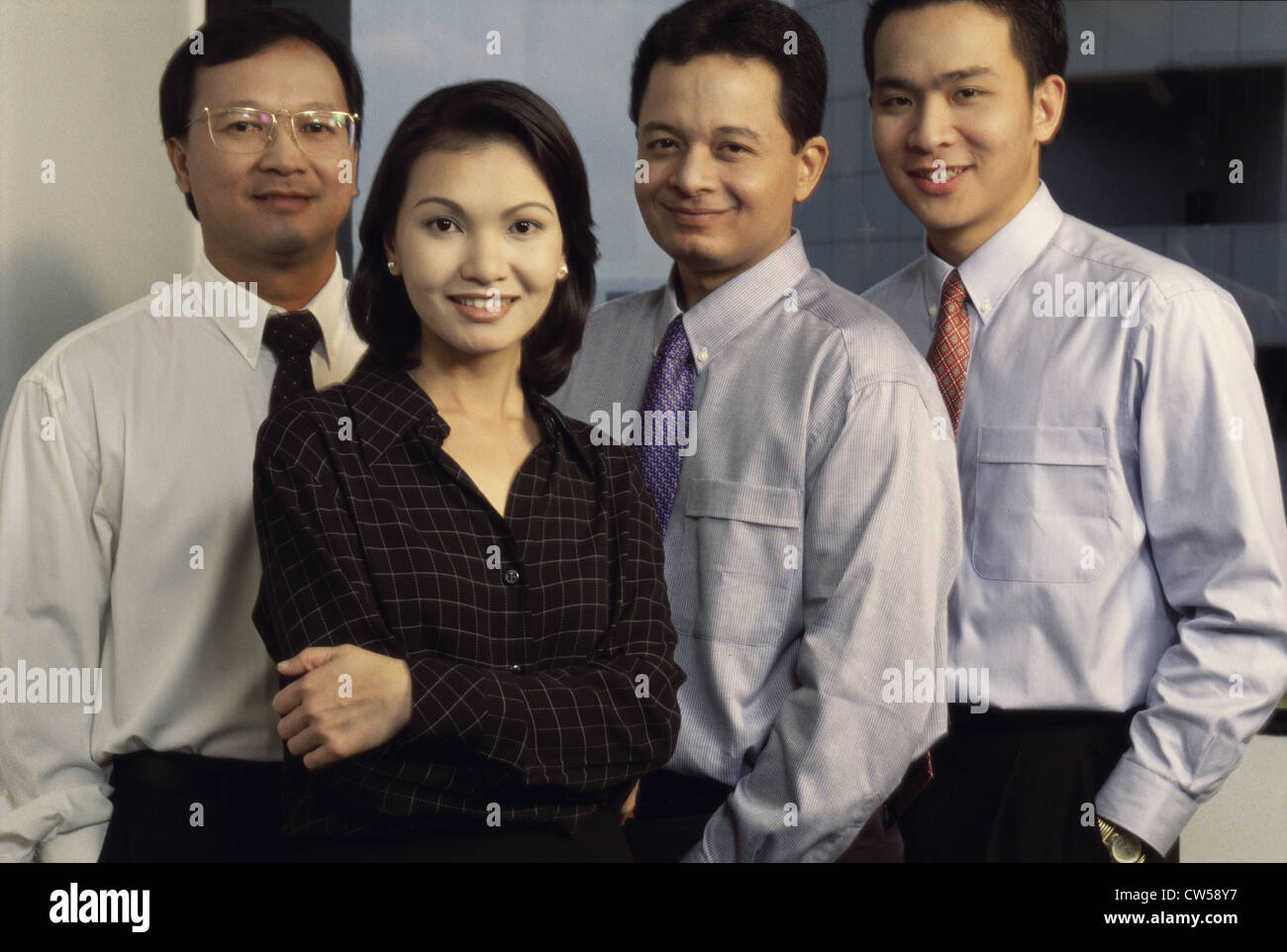Portrait of three businessmen and a businesswoman in an office Stock ...