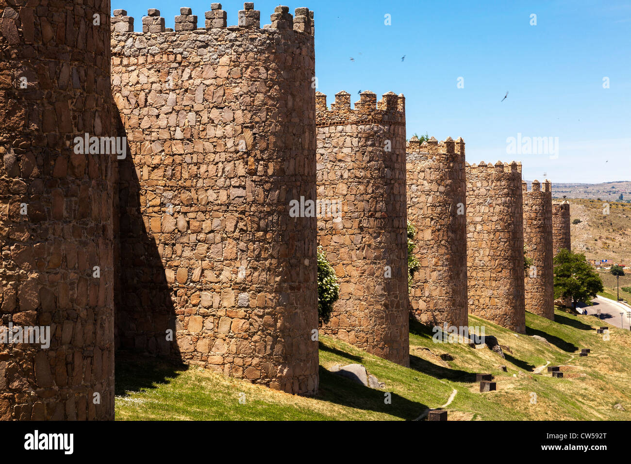 The fortification of the medieval city walls of Avila under a clear blue sky, Castile and León, Spain, Europe. Stock Photo