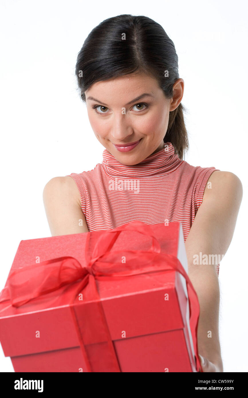 Portrait of a young woman holding a gift and smiling Stock Photo - Alamy