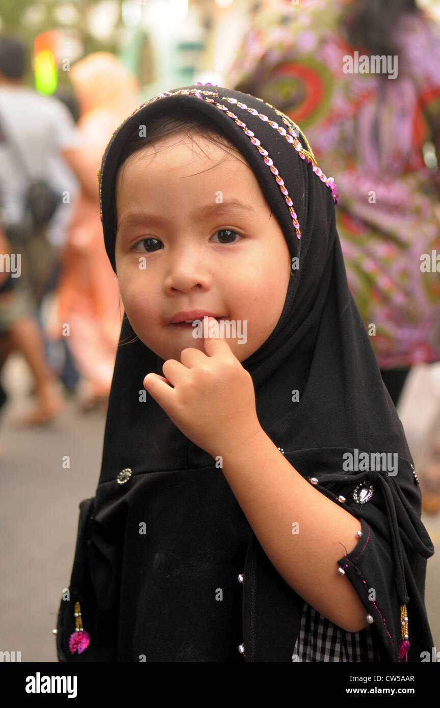 muslim girl in traditional dress and head scarf  during mosque festival, bangkok , thailand Stock Photo