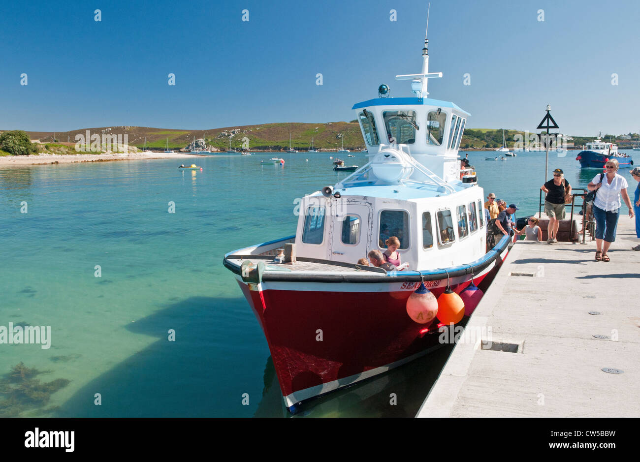Holidaymakers disembarking at Church Quay on Bryher Isles of Scilly West of England Stock Photo