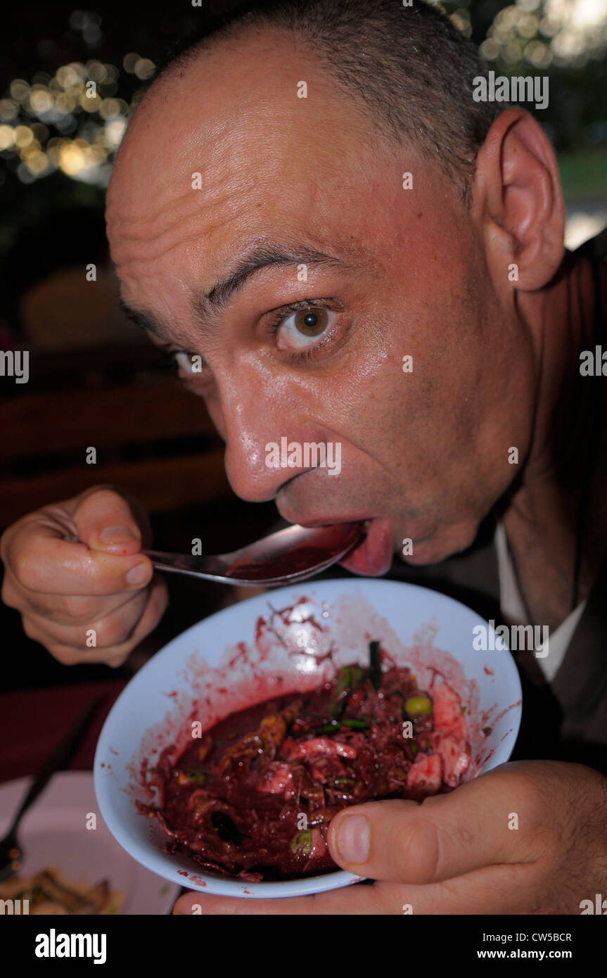 eating raw pig skin and liver in fresh pig blood, weird taste,strange