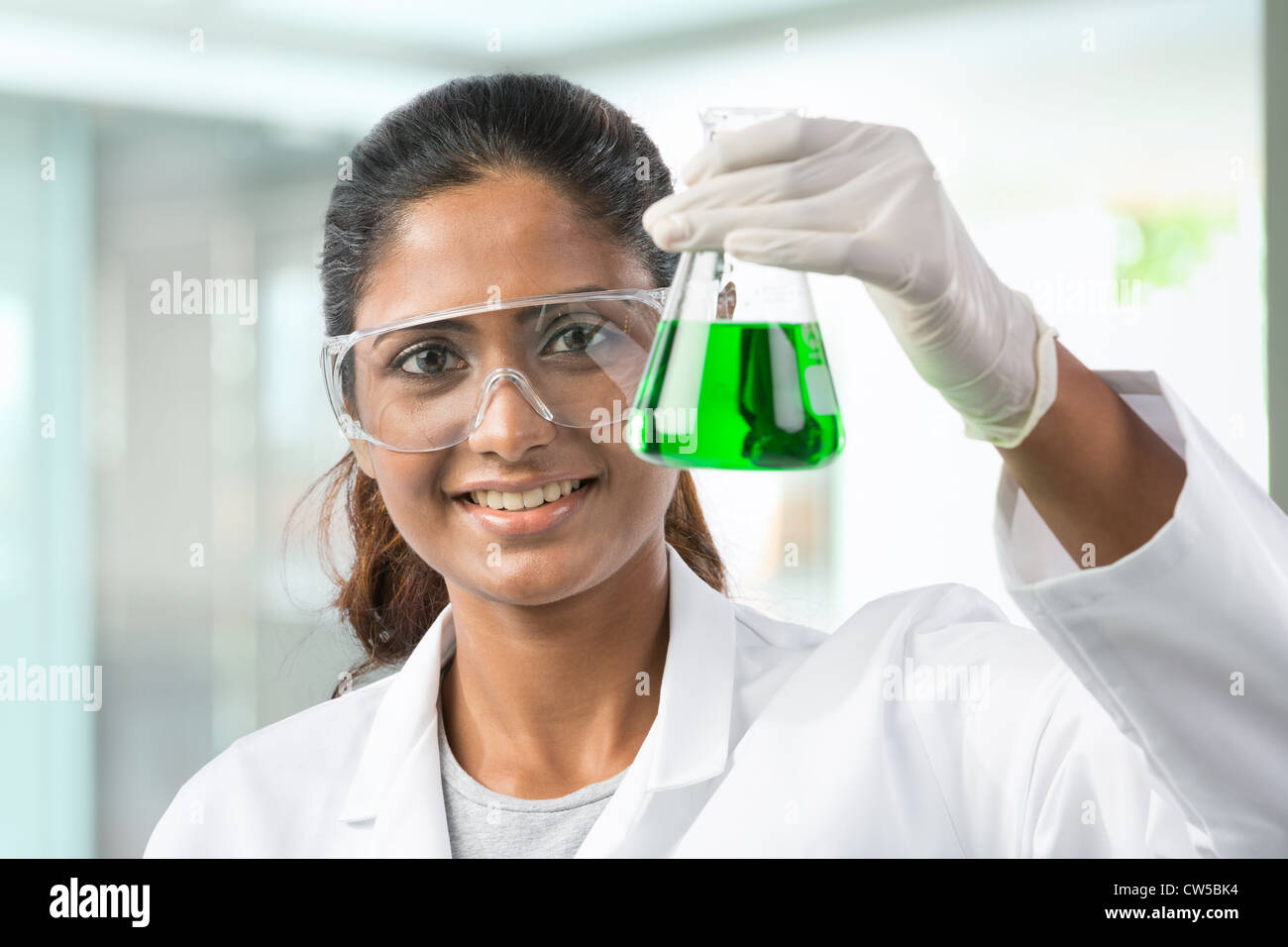 Woman scientist analyzing a solution. Stock Photo