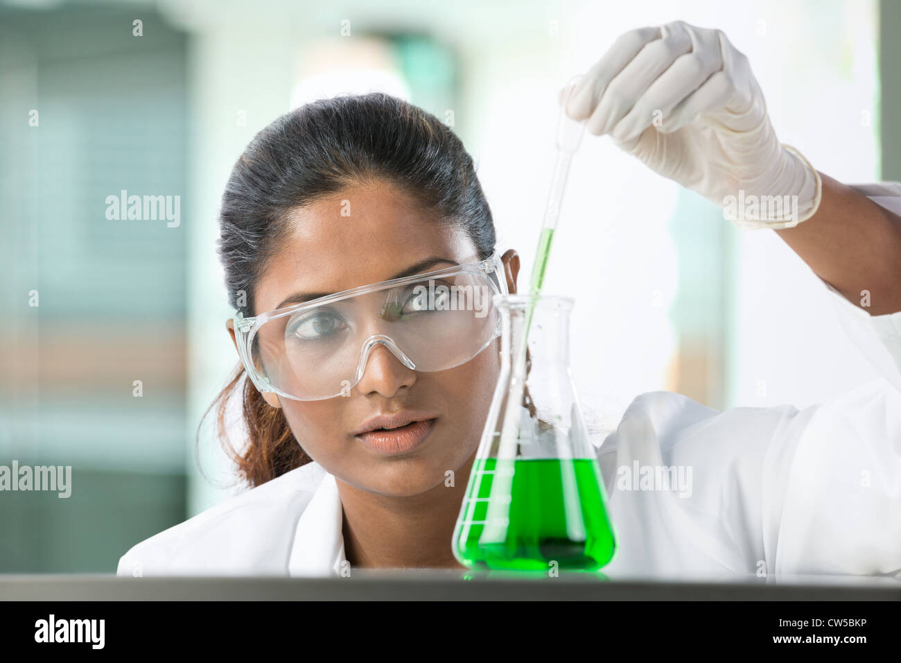 Woman scientist analyzing a solution. Stock Photo