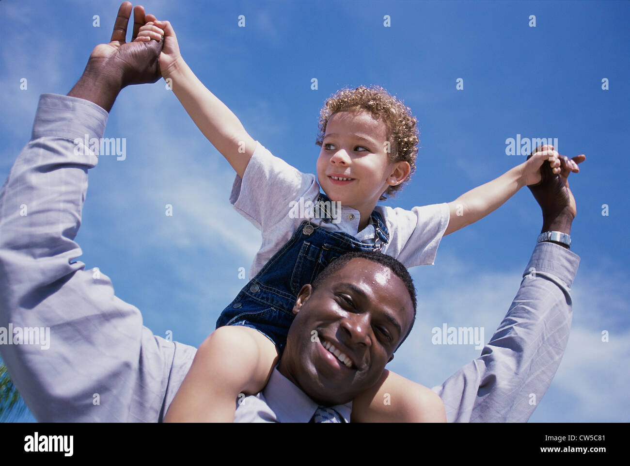 Father carrying his son on his shoulders Stock Photo - Alamy