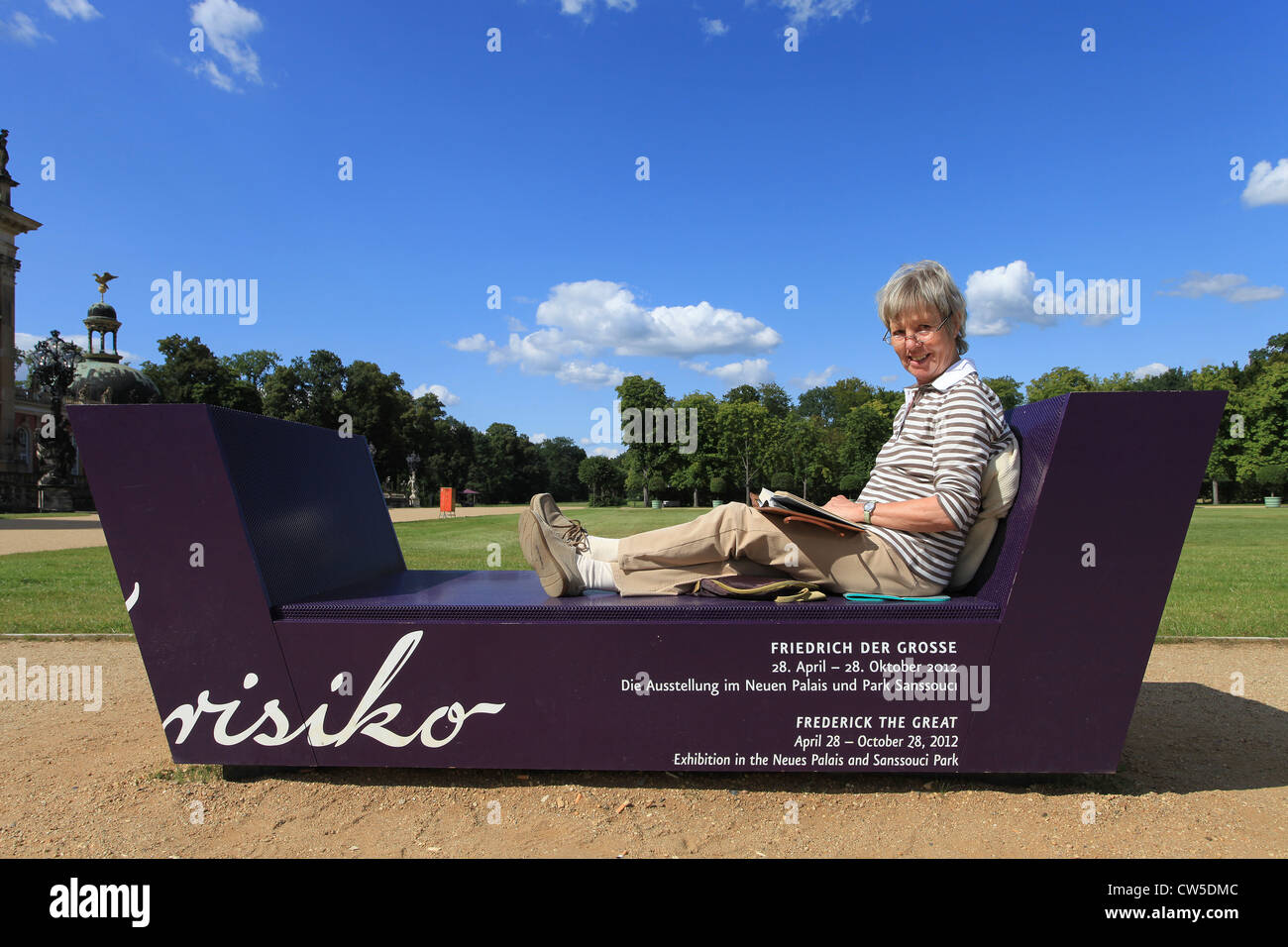 A woman reading a brochure about Frederick the Great during her visit of the exhibition 'Friederisiko'. Sanssouci Park, Potsdam. Stock Photo