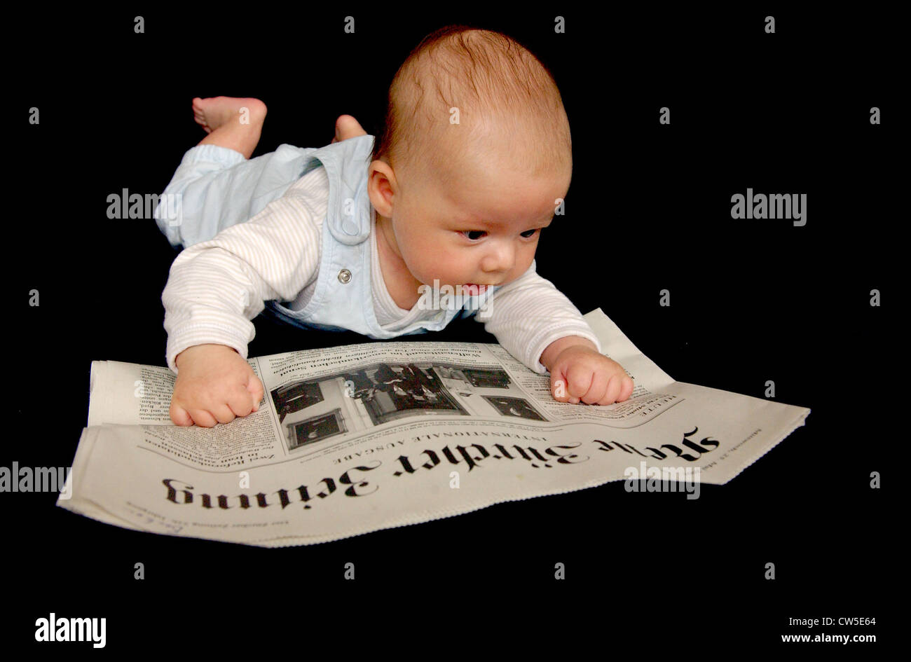 Baby reading newspaper Stock Photo Alamy