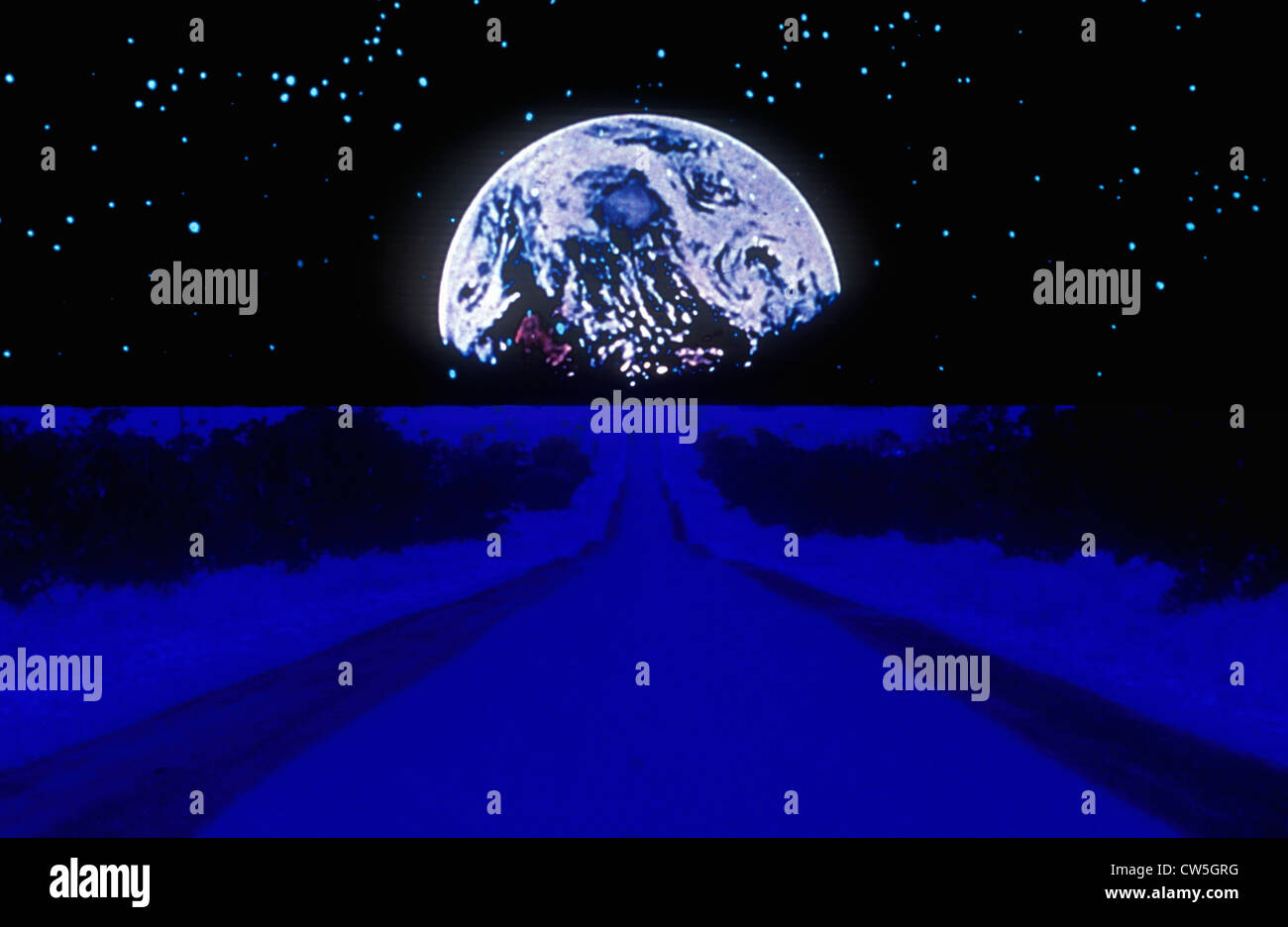 Earth against a starry background above a glowing blue highway extending to the horizon Stock Photo