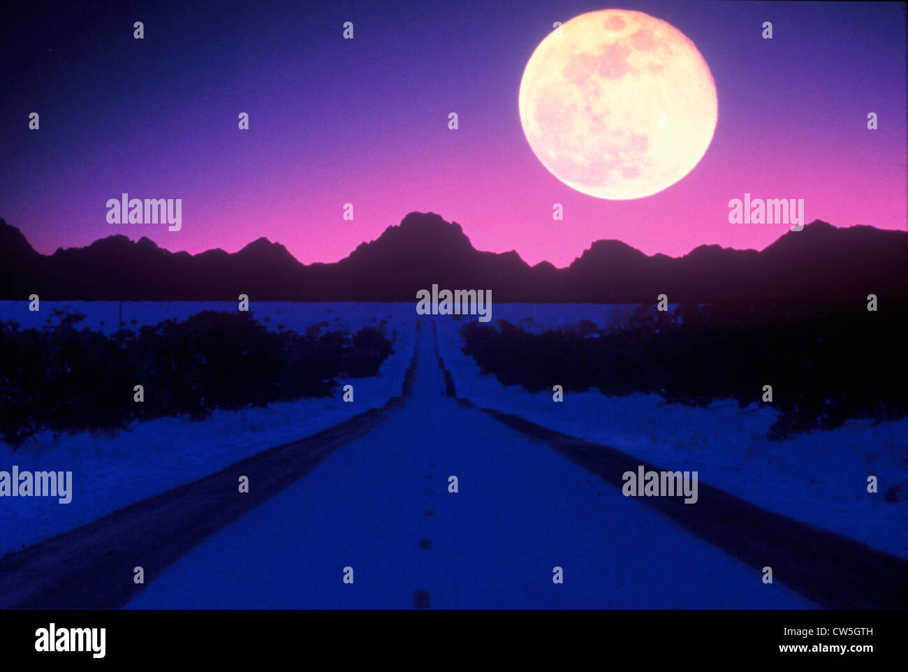 Moonrise over an alien landscape Stock Photo