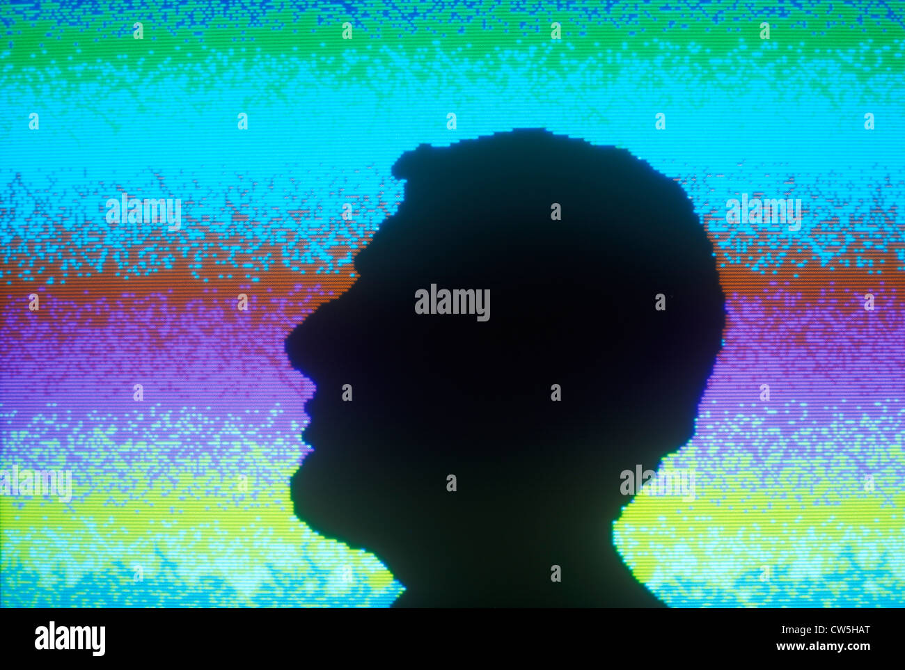 Early computer graphic of silhouette of head against colored background Stock Photo