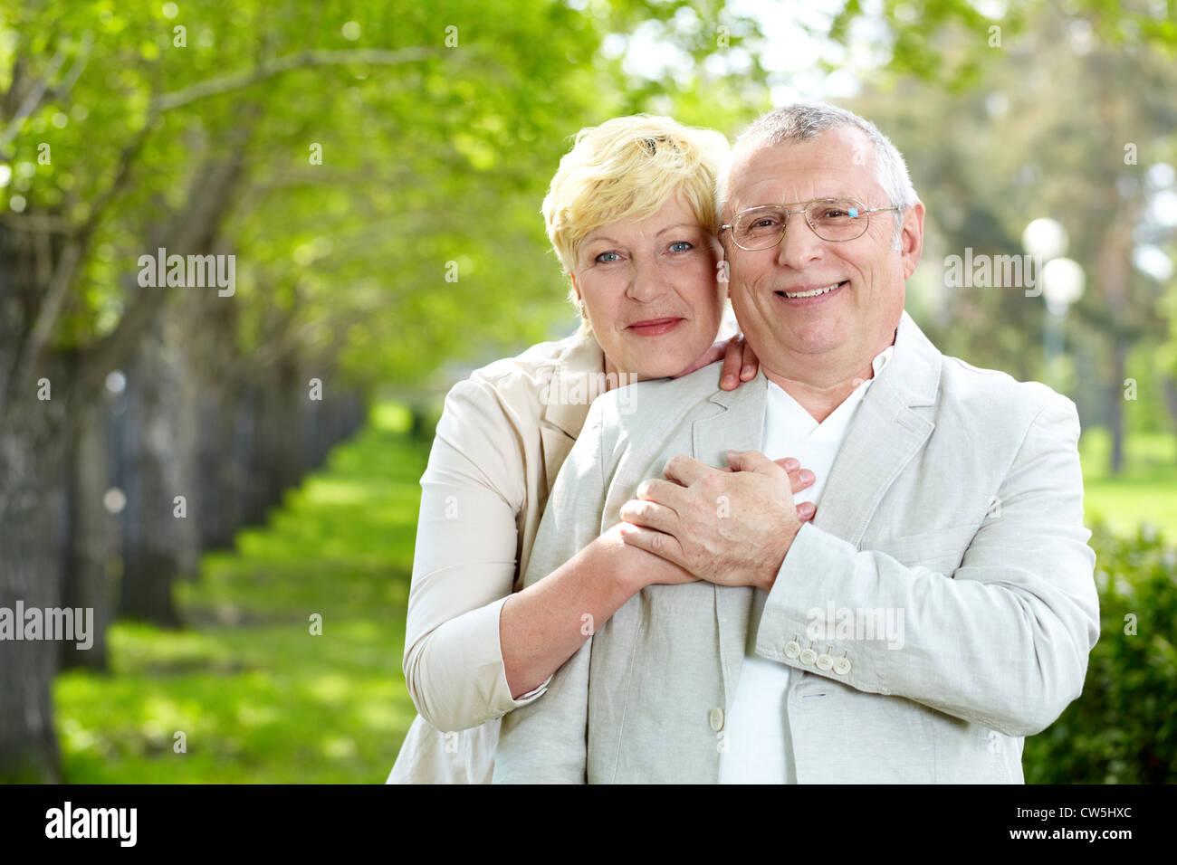 Portrait of happy mature woman hugging her husband outside Stock Photo ...