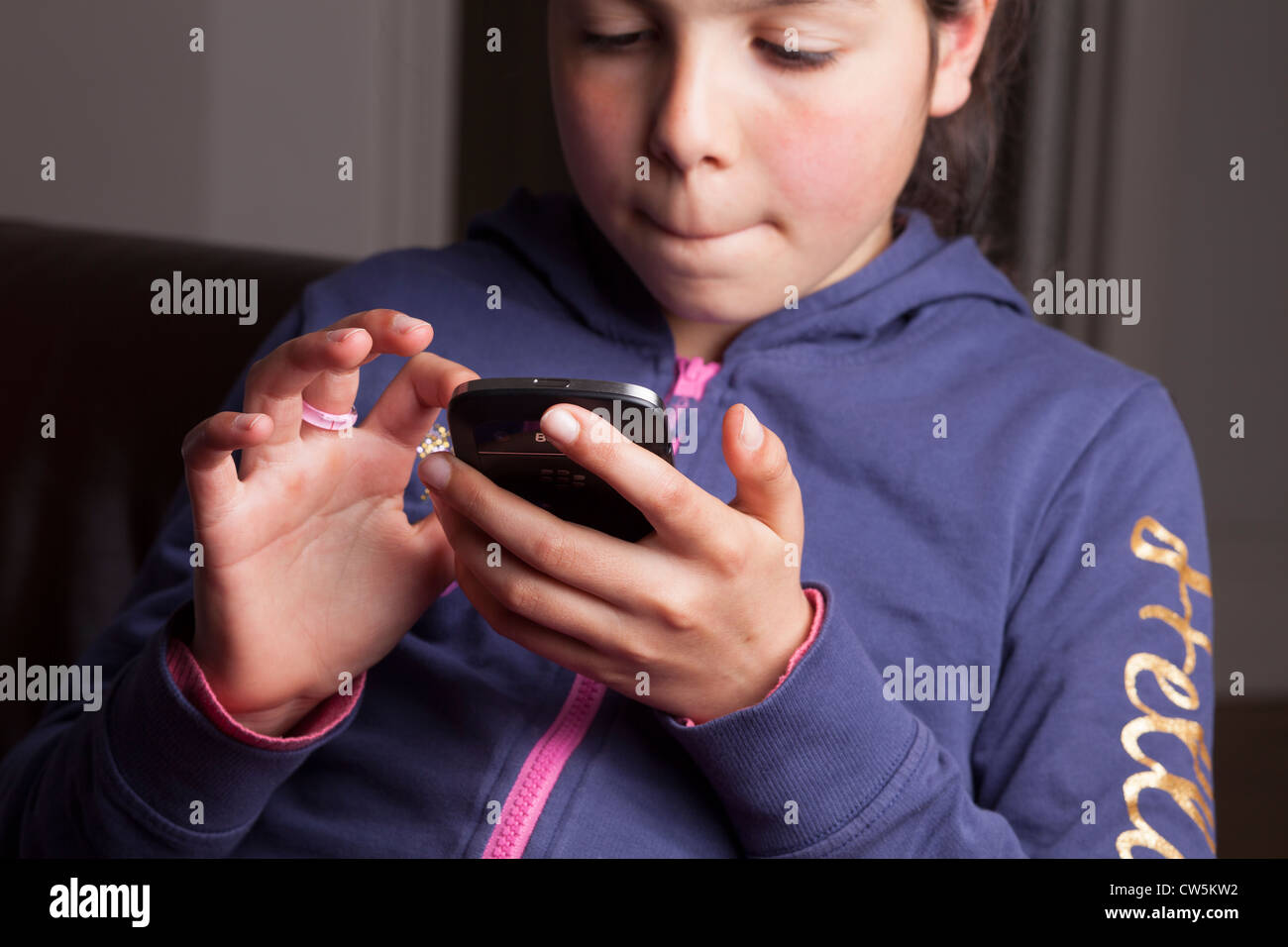 Child texts on  a Blackberry Smart Phone Stock Photo