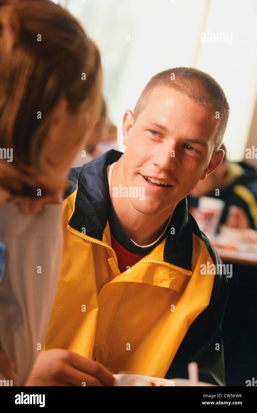 Young man talking with a woman in a classroom Stock Photo - Alamy