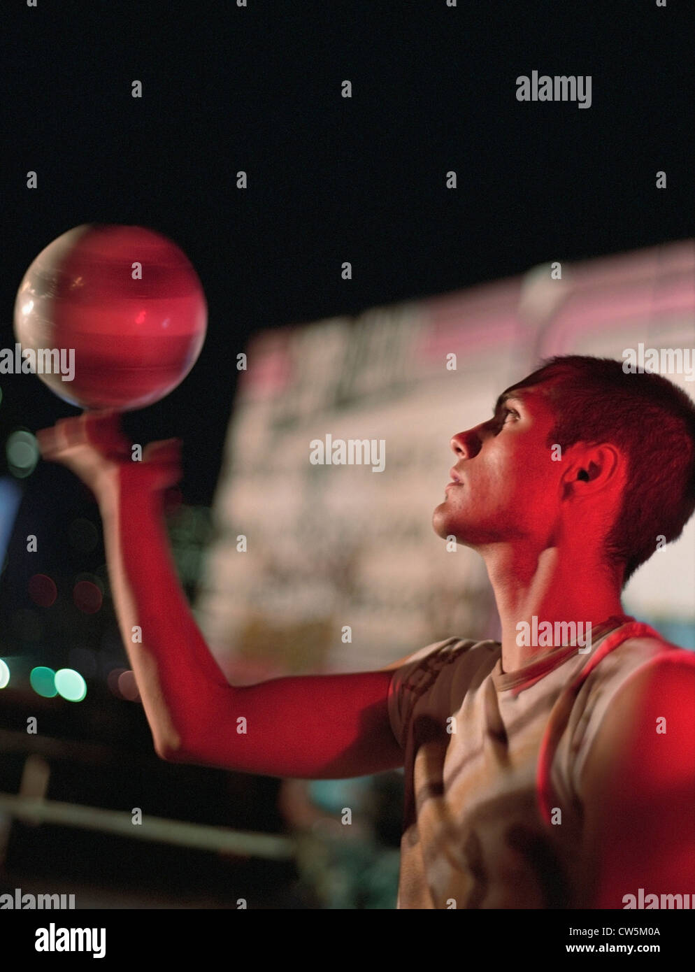 Young man twirling a basketball on his finger Stock Photo