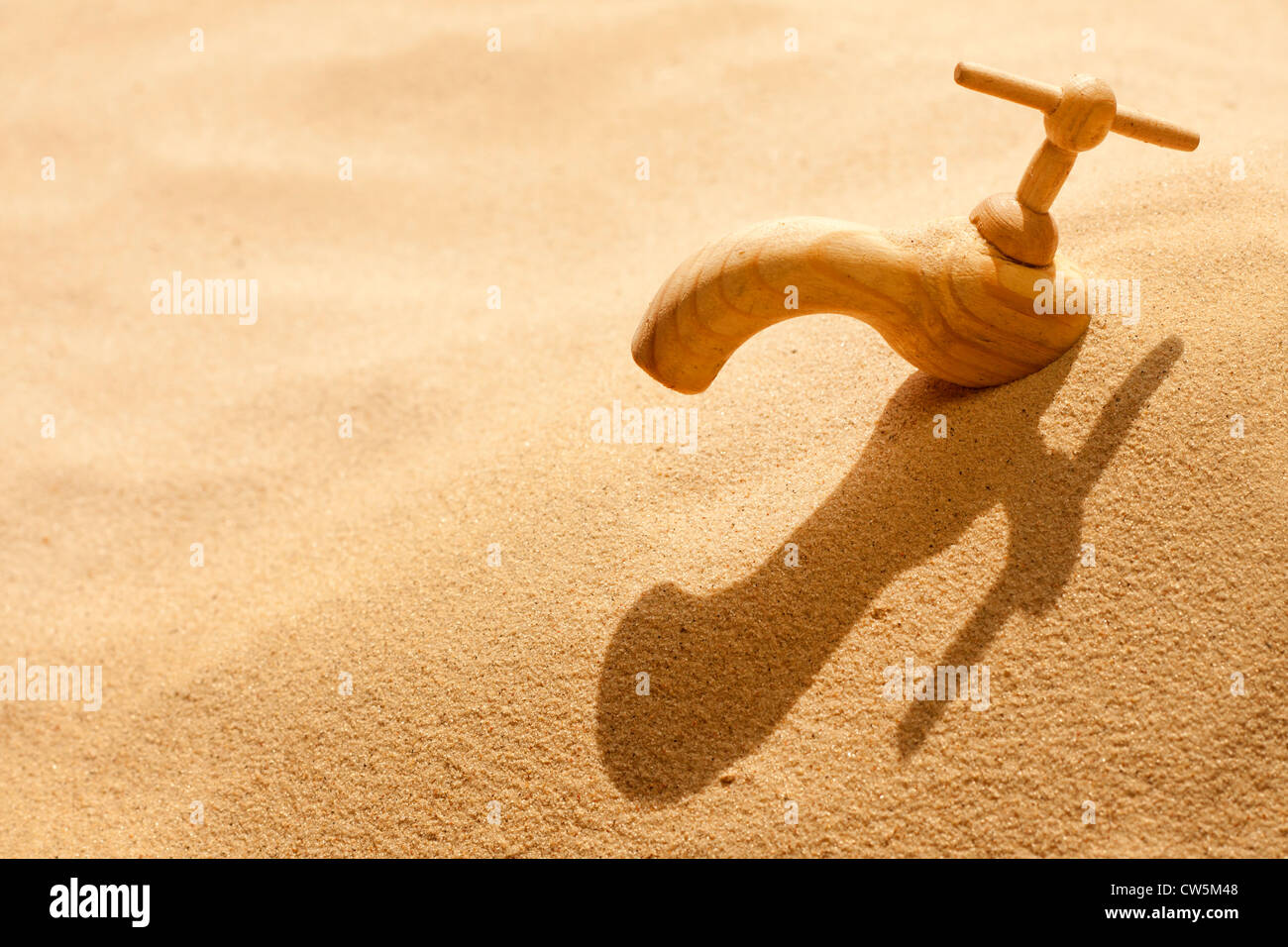 Global warming climate change faucet in the sand concept Stock Photo