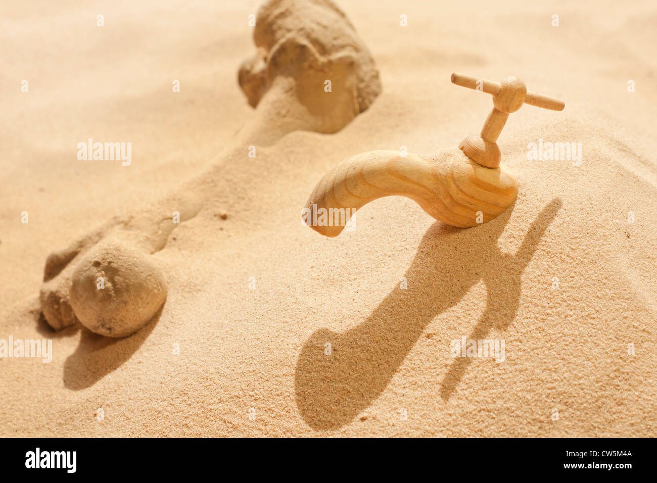 Global warming climate change faucet in the sand concept Stock Photo