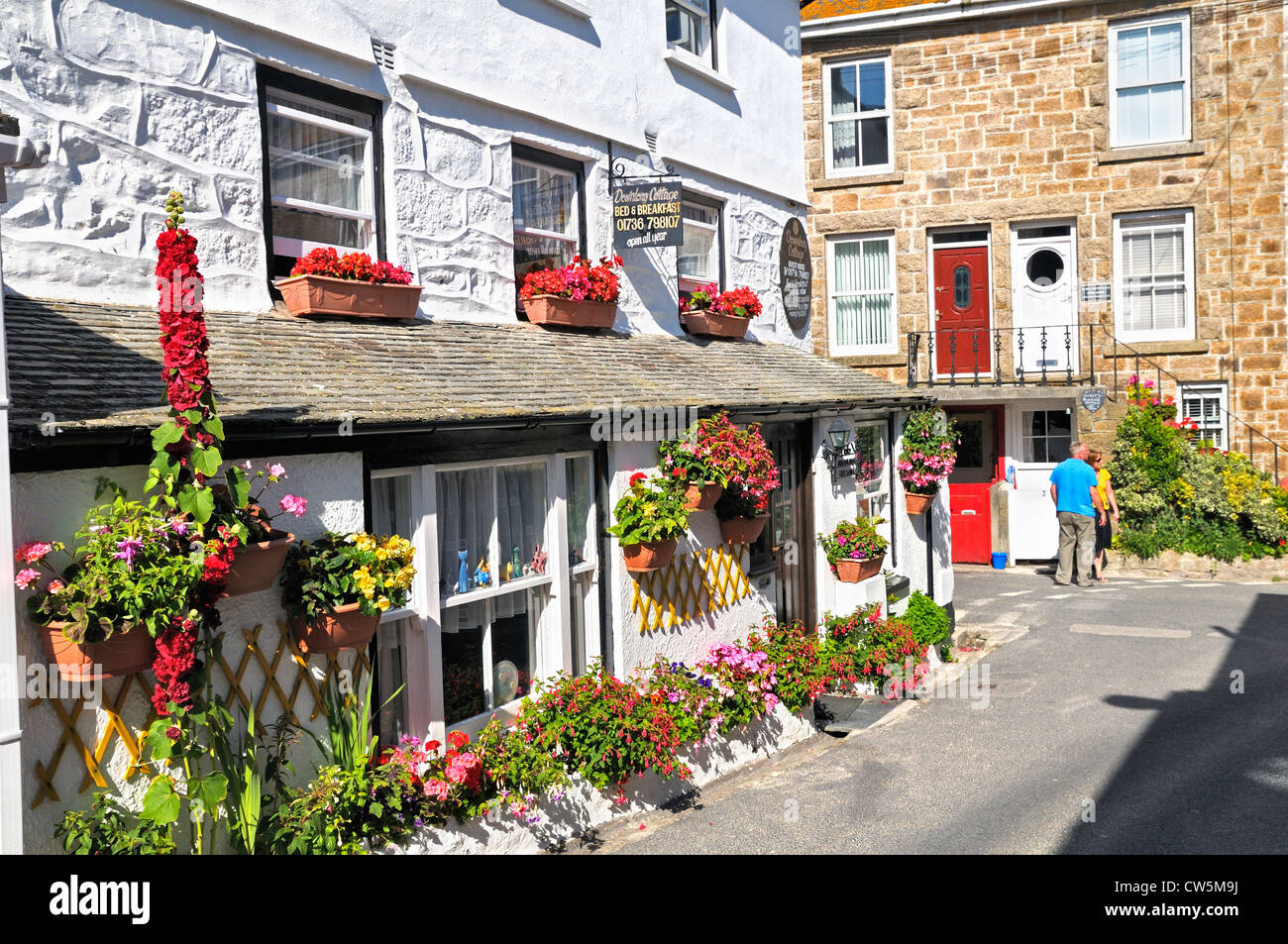 B&B cottage adorned with summer flowers, St Ives, Cornwall, UK Stock Photo